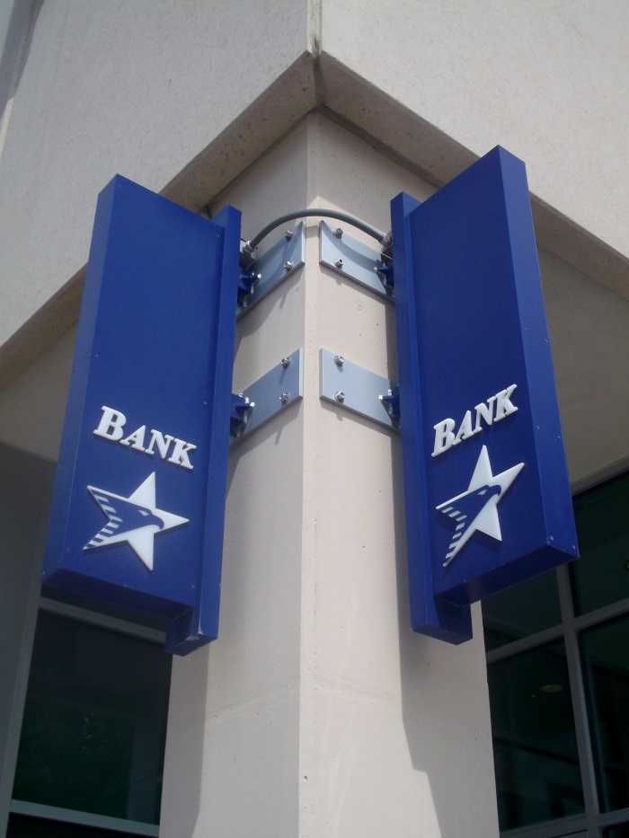 Non-illuminated, double-face American National Bank projecting signs located downtown 