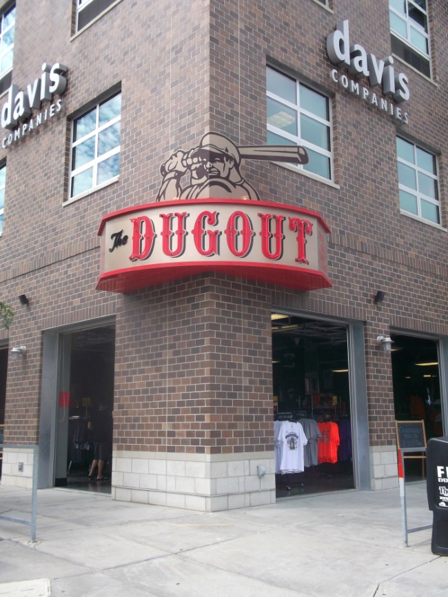 Neon illuminated projecting sign for The Dugout across from TD Ameritrade Park