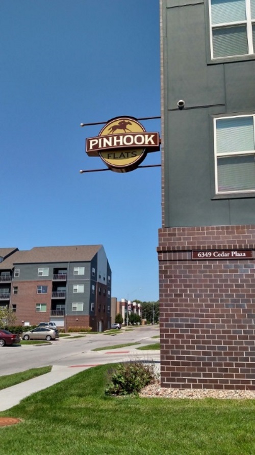 Non-illuminated, double-face projecting sign for Pinhook Flats at Aksarben Village
