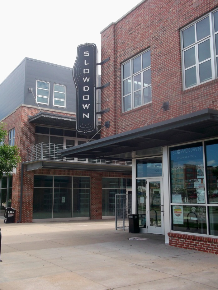 Neon illuminated, double-face projecting sign for the Slowdown