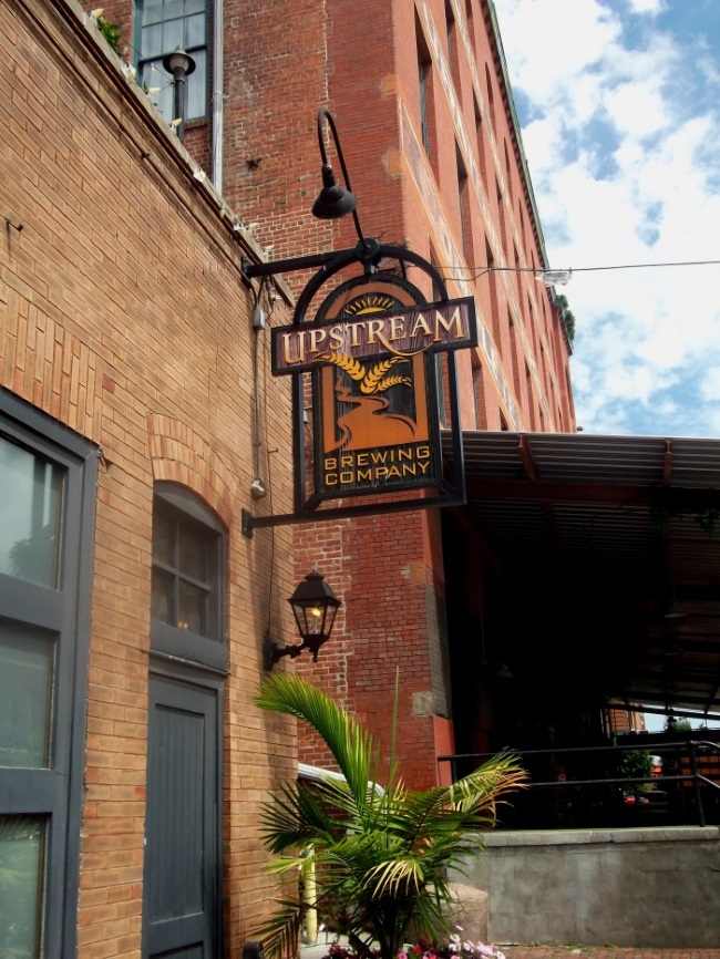 Non-illuminated, double-face projecting sign for Upstream in the Old Market