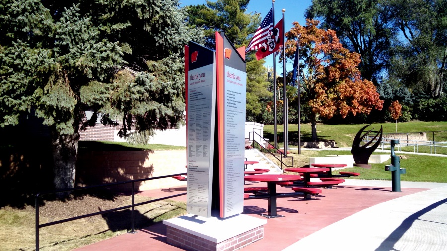 Non-illuminated, three sided West Side High School donation monument sign by the football field